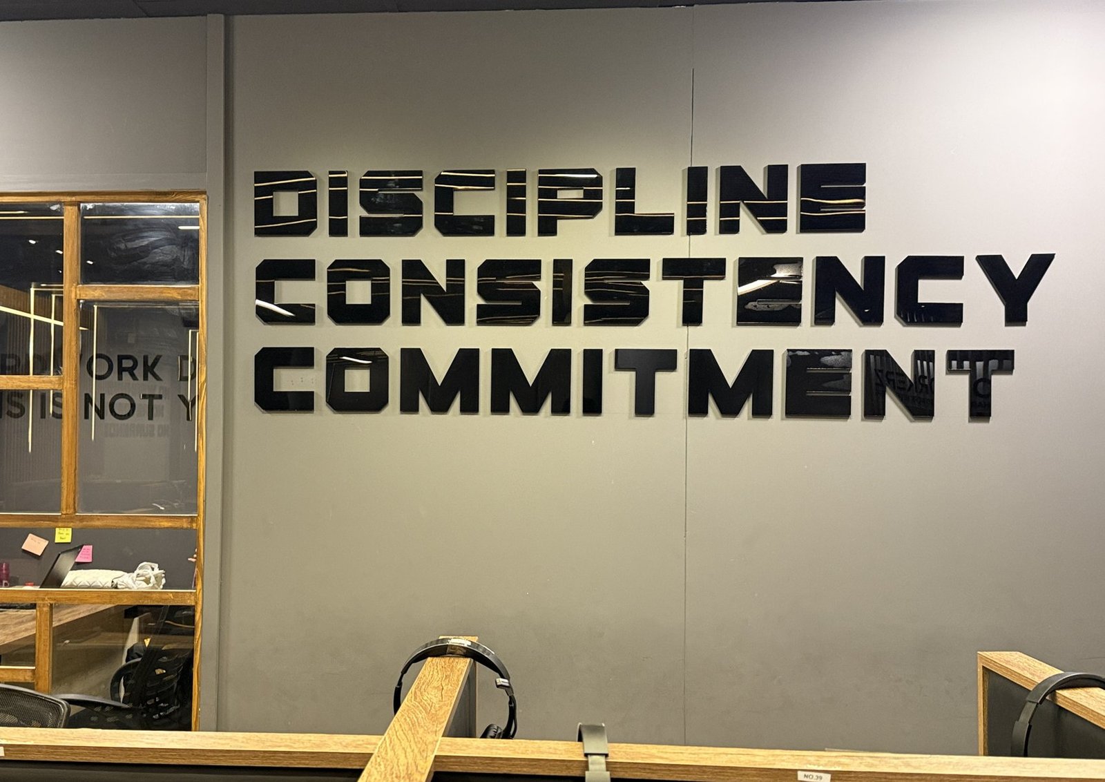 Discipline, Consistency, Commitment on the wall at the Workerz office